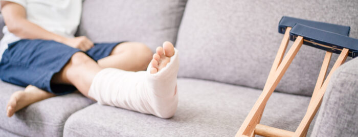 Someone with a broken leg sitting on a couch