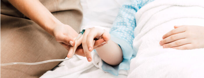 A nurse holding a patient's hand